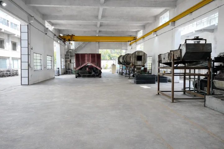 A production hall with an overhead crane and machines staged along the bay