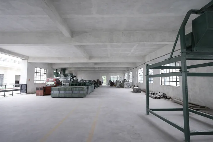 A long fabrication hall with equipment along both sides
